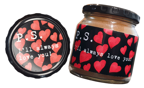 Unique gift for boyfriends and girlfriends. A scented candle in a jar and the lid of the jar with a label that reads "P.S. I'll Always Love You".