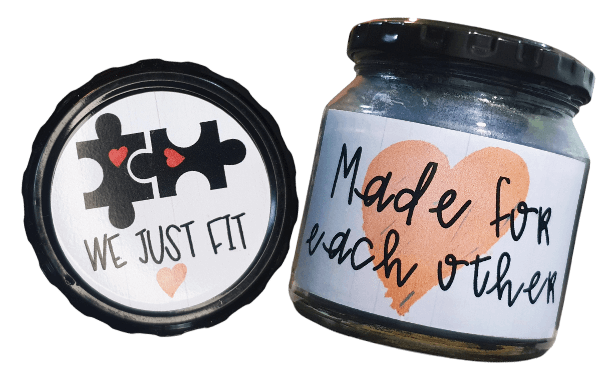Unique gift for boyfriends and girlfriends. A scented candle in a jar and the lid of the jar with a label that reads "We just fit. Made for each other".